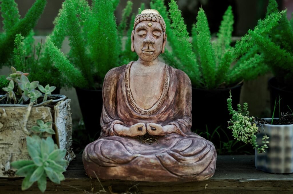 A Buddha statue sitting among plants at one of the healing retreats in Bali.