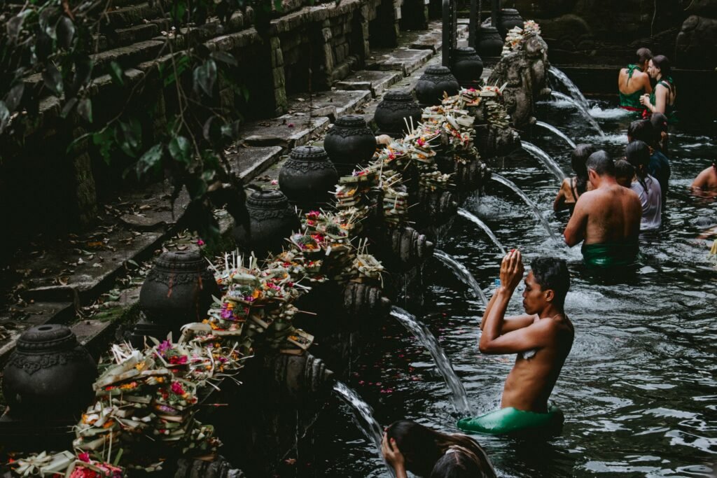 People being purified by water at a sacred sit in Bali.
