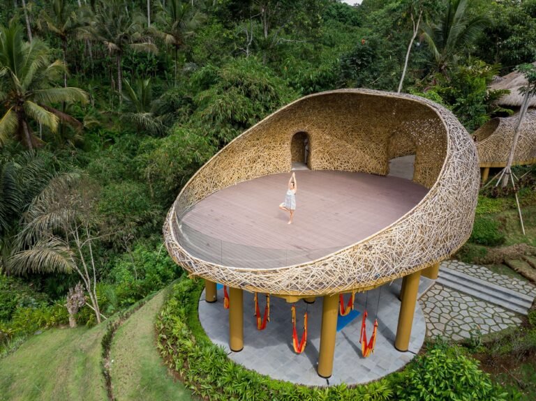 A woman doing yoga on a raised platform at one of the healing retreats in Bali.