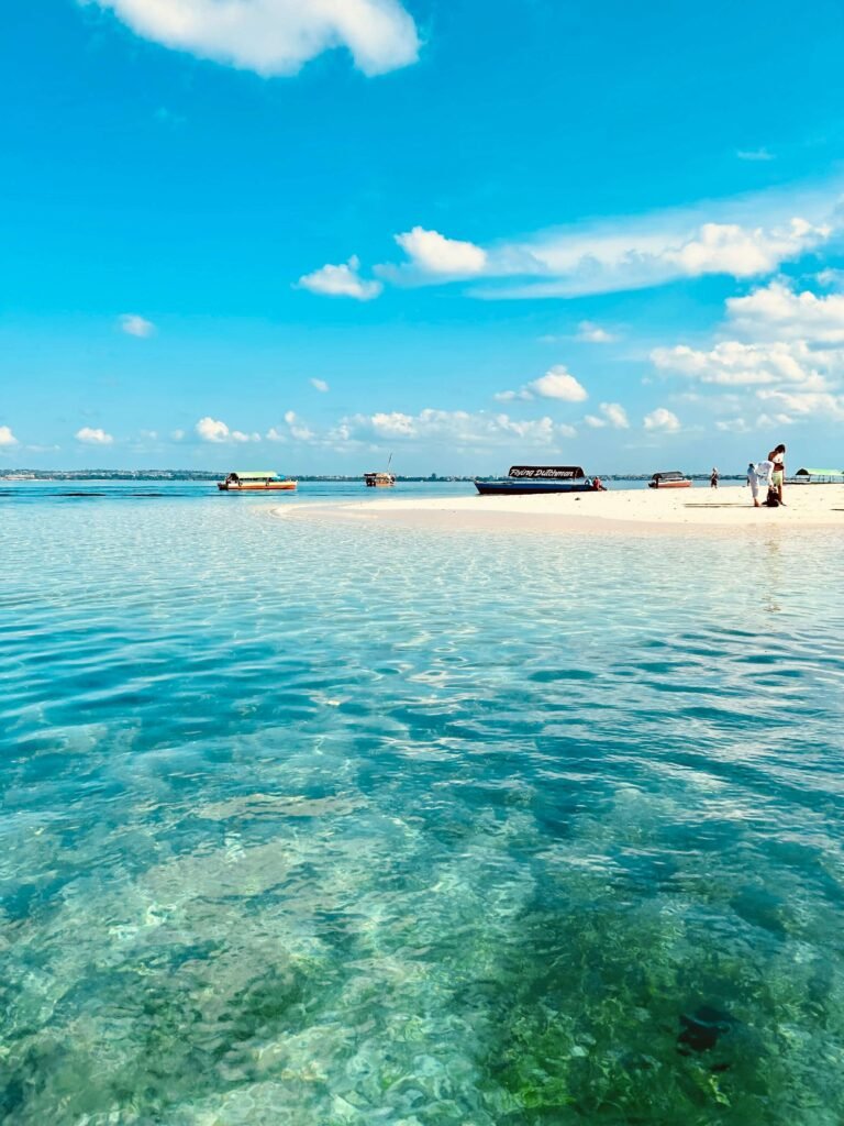 Traditional Zanzibari dhows arriving at Prison Island one of the best Zanzibar snorkeling spots.