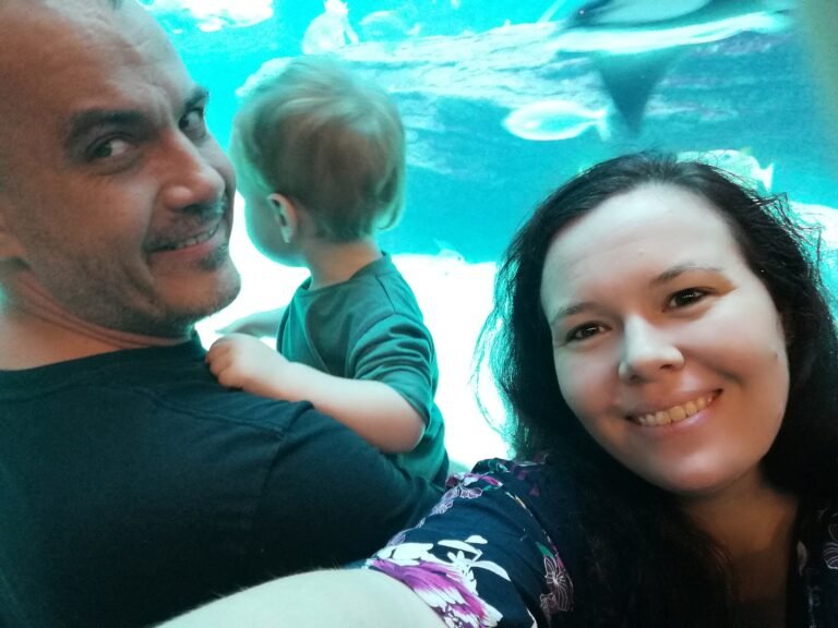 A travel family at an aquarium inspired by family travel quotes.