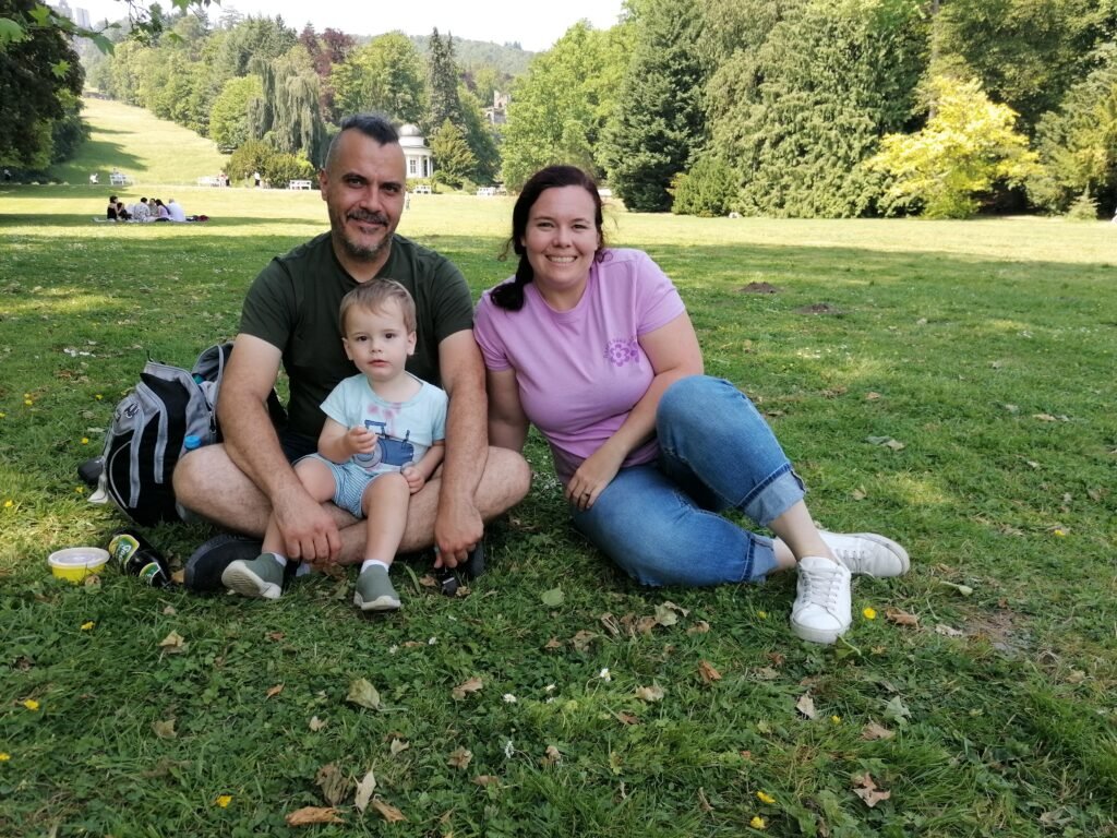 A family sitting in a park in Germany.