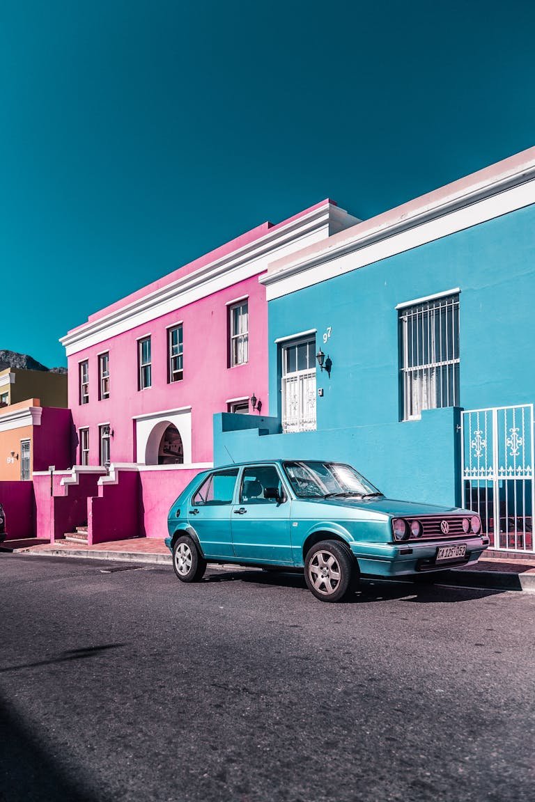 Parked Blue Car Beside Building that was driving in Cape Town.