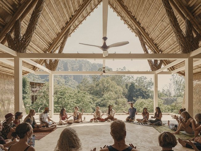 A group of people meditating in a shala at one of the New Year Yoga Retreats.