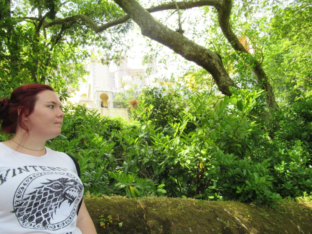 A woman wondering where to stay in Sintra while standing in front of Pena Palace.