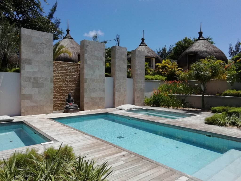 A calming spa courtyard with 3 pools, a garden and a statue.