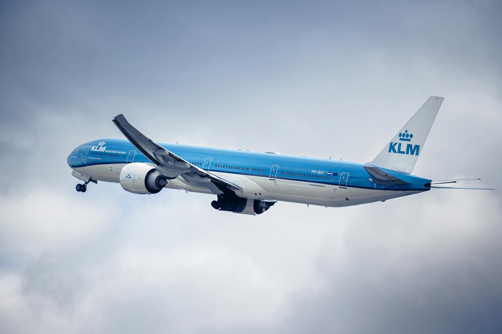 KLM aircraft flying through a cloudy sky, showcasing aviation and travel.