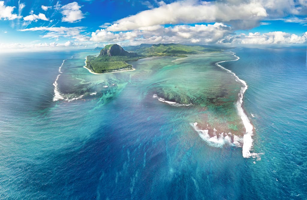 Explore the breathtaking Le Morne Peninsula, a UNESCO World Heritage site in Mauritius, from above.